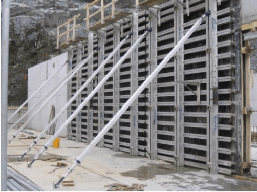 Large aluminum gang form being lifted by crane